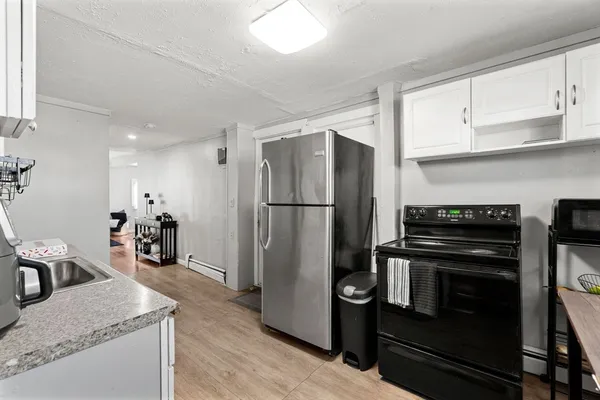 a kitchen with a refrigerator and a sink