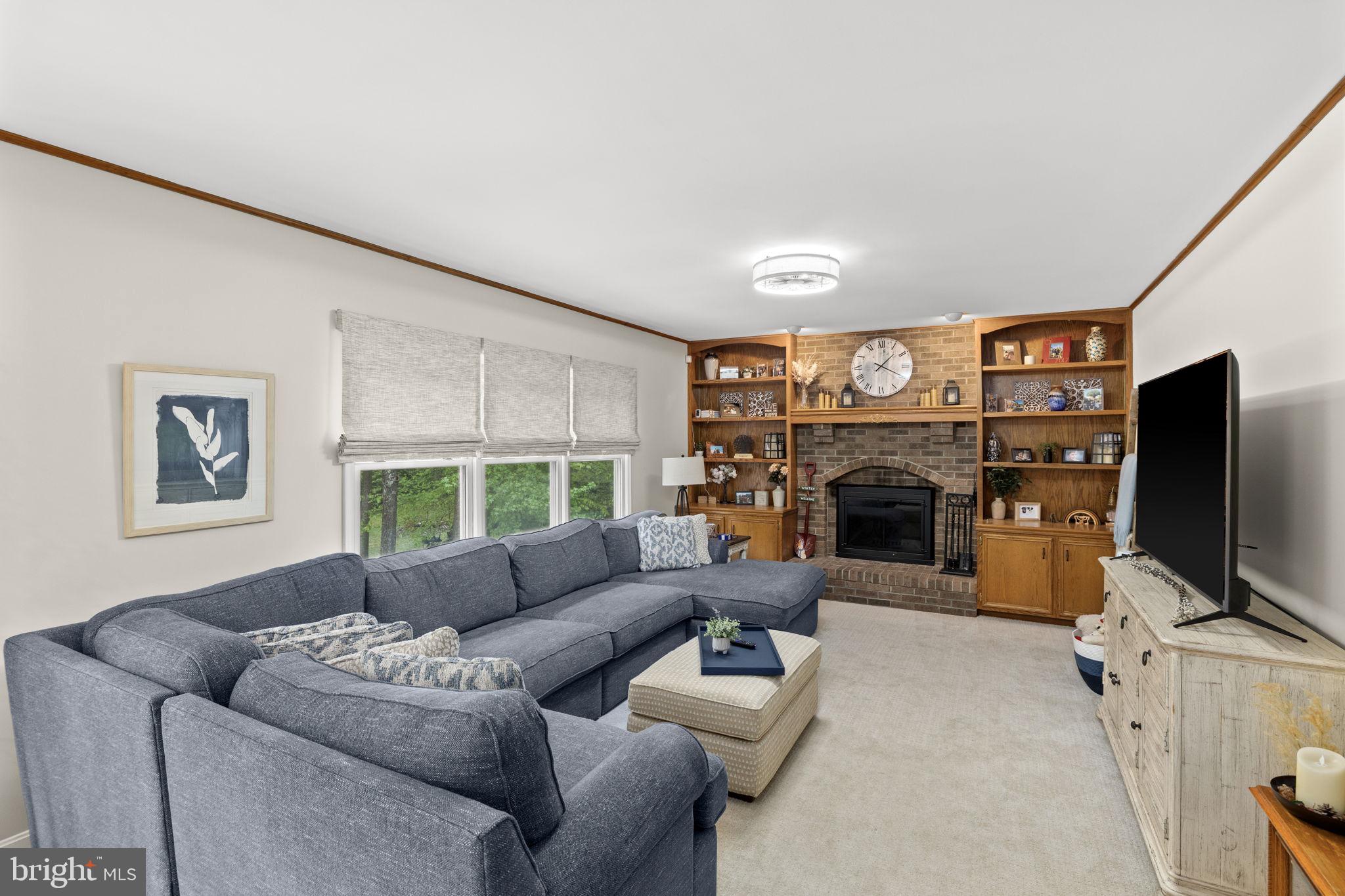 100 Boscobel Road Fredericksburg, VA 22405 - Photo 28 of 67 a living room with furniture a fireplace and a flat screen tv