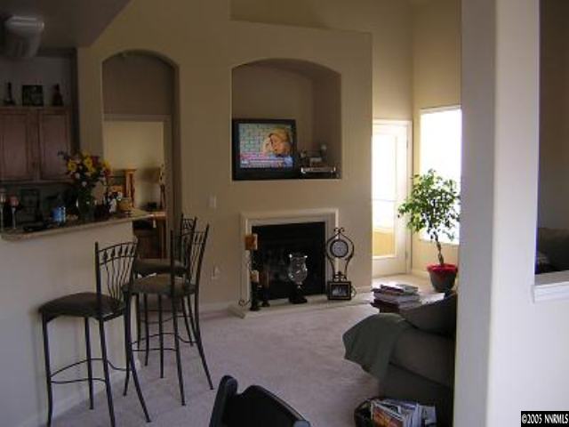 9050 Double R Bvld, Unit 1221 Reno, NV 89521 - Photo 3 of 8 a living room with furniture and a fireplace