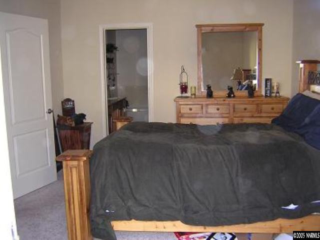 9050 Double R Bvld, Unit 1221 Reno, NV 89521 - Photo 5 of 8 a bedroom with a bed and wooden floor