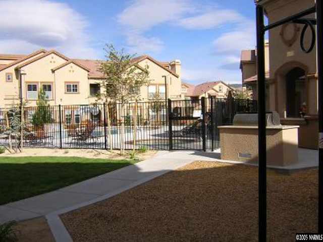 9050 Double R Bvld, Unit 1221 Reno, NV 89521 - Photo 7 of 8 a view of a house with a yard and porch
