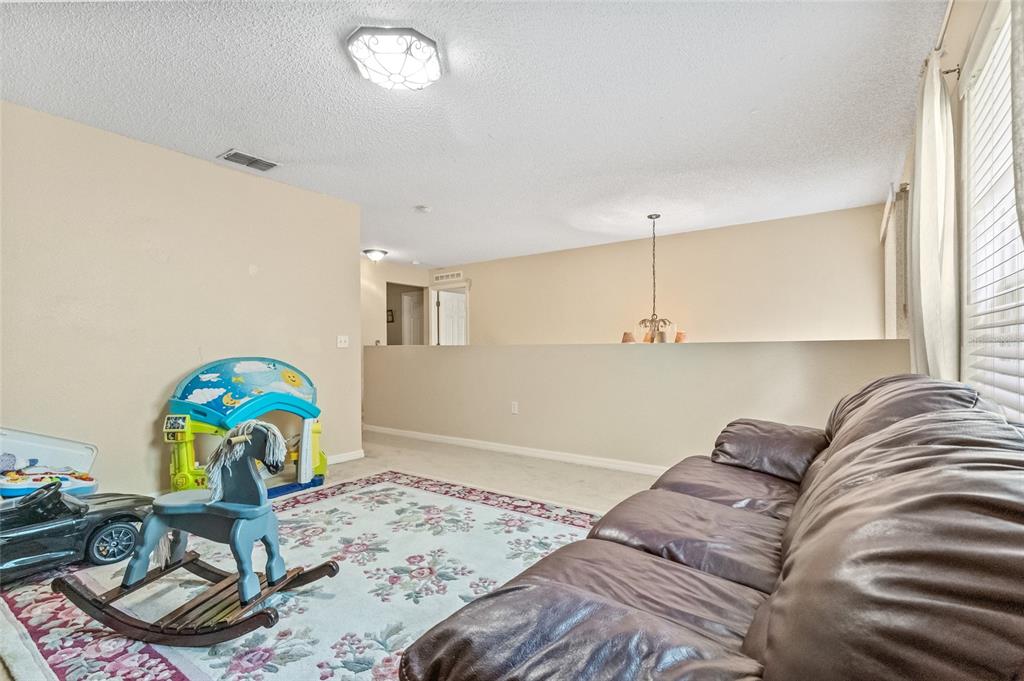 10311 Frog Pond Drive Riverview, FL 33569 - Photo 11 of 39 a bedroom with a bed and a chandelier