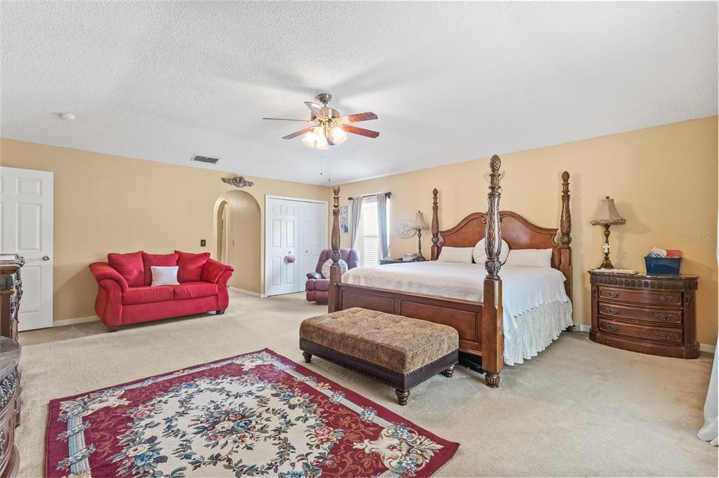 10311 Frog Pond Drive Riverview, FL 33569 - Photo 13 of 39 a bedroom with furniture and a chandelier