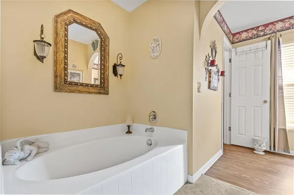 a bathroom with a tub and shower