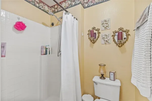 a bathroom with a sink mirror and toilet