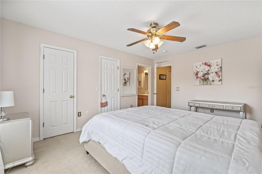 10311 Frog Pond Drive Riverview, FL 33569 - Photo 20 of 39 a bedroom with a bed and a chandelier