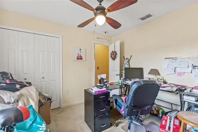 a view of a workspace with furniture and a window