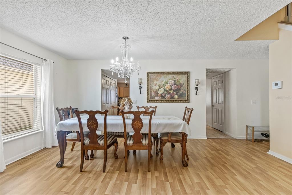 10311 Frog Pond Drive Riverview, FL 33569 - Photo 24 of 39 a view of a dining room with furniture wooden floor and chandelier