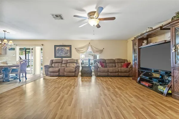 a living room with furniture or couch and a wooden floor