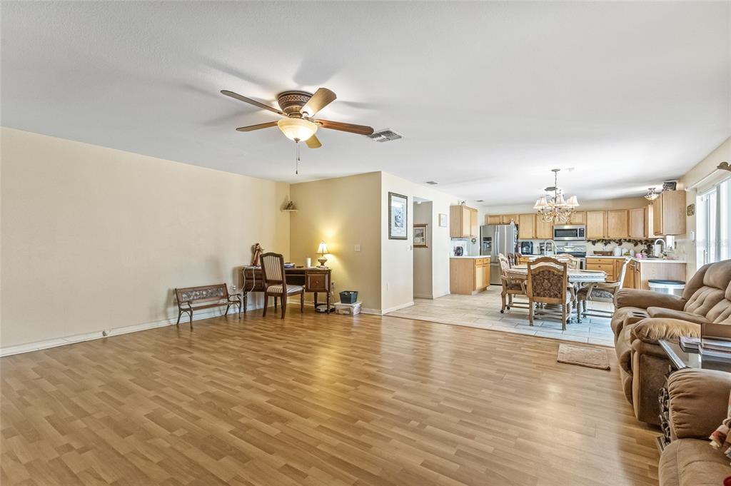 10311 Frog Pond Drive Riverview, FL 33569 - Photo 27 of 39 a living room with furniture and a dining table with wooden floor