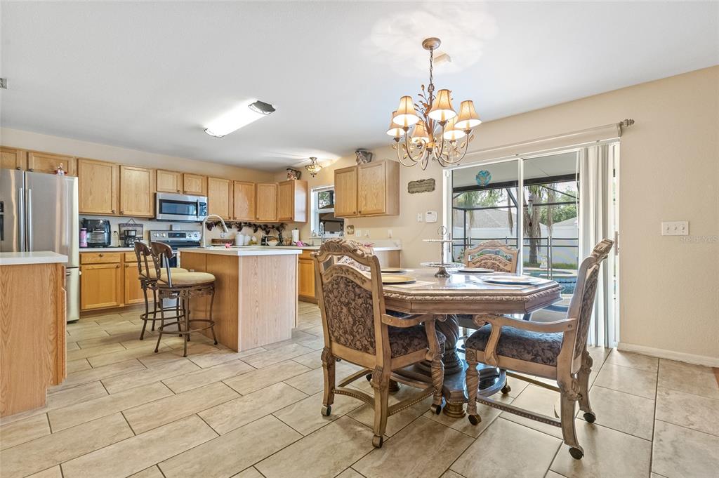 10311 Frog Pond Drive Riverview, FL 33569 - Photo 28 of 39 a view of a dining room with furniture a chandelier and wooden floor