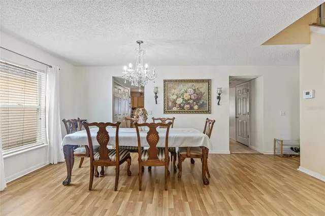 a view of a dining room with furniture wooden floor and chandelier