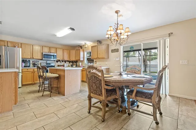 a dining room filled with furniture and a chandelier