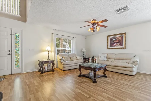 a living room with furniture and wooden floor