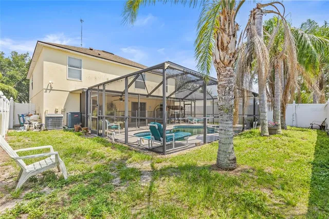 a backyard of a house with table and chairs