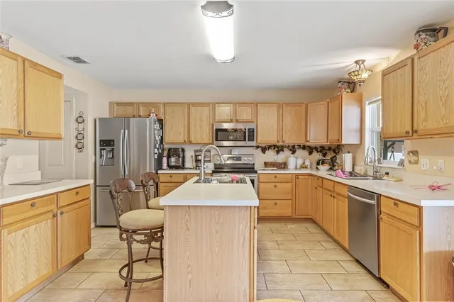 a kitchen with stainless steel appliances granite countertop a refrigerator sink and cabinets