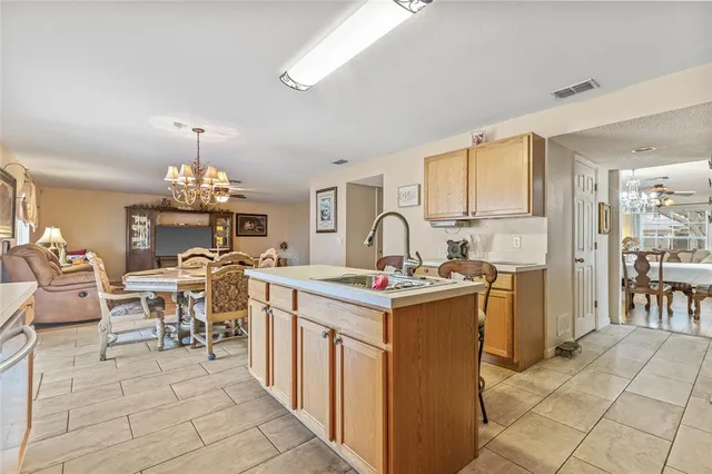 a view of a kitchen with dining area a sink and dishwasher kitchen view