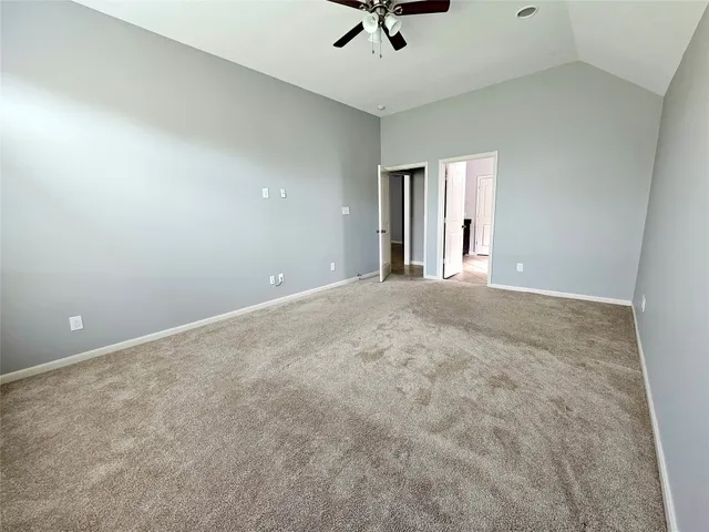 a view of a livingroom with a ceiling fan and window