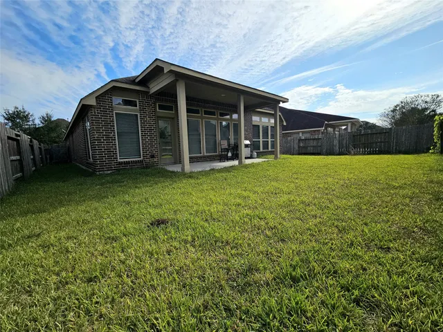 a big house with a big yard and large trees