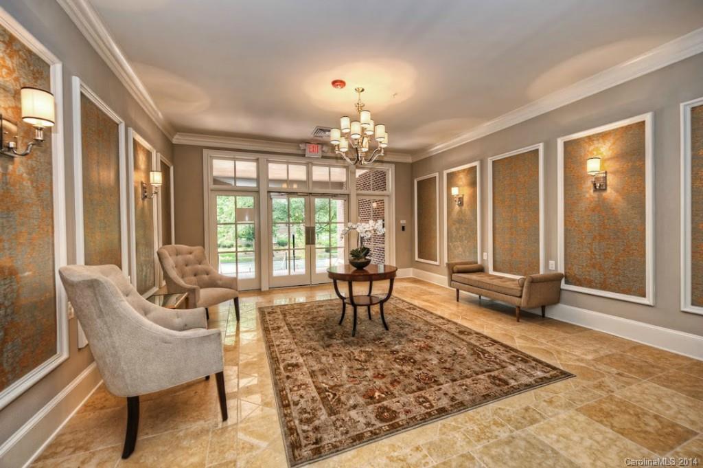 2128 Queens Road West, Unit 2128 Charlotte, NC 28209 - Photo 2 of 21 a living room with furniture and a chandelier