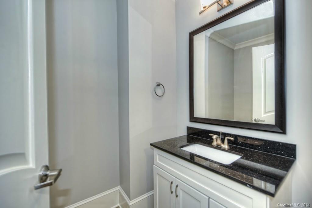 2128 Queens Road West, Unit 2128 Charlotte, NC 28209 - Photo 17 of 21 a bathroom with a granite countertop sink and a mirror