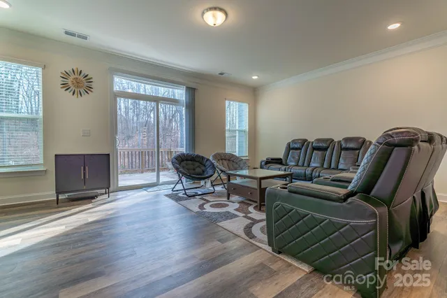 a living room with furniture a rug and a window