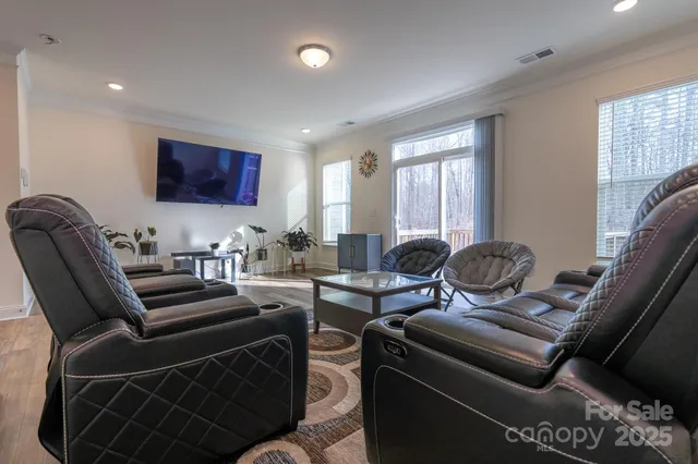 a work room with furniture windows and a flat screen tv