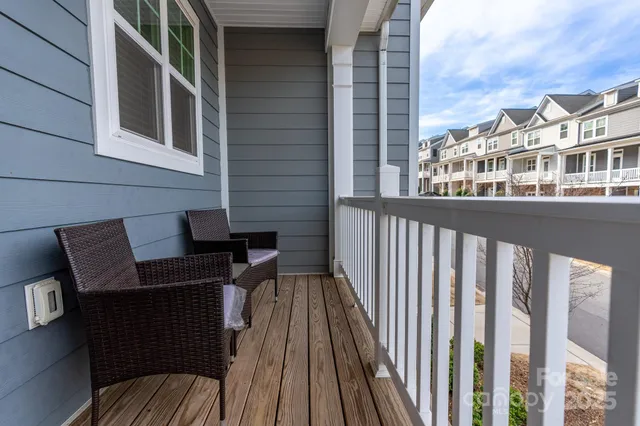 a view of a balcony with two chairs and a table