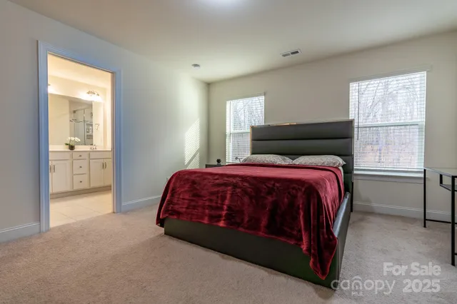 a bed sitting in a bedroom next to a window