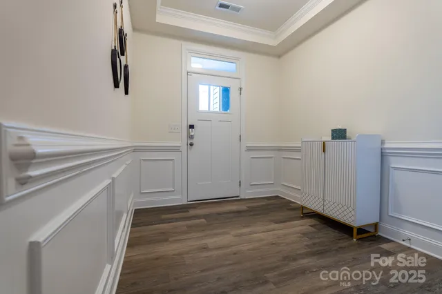 a view of a kitchen with wooden floor and cabinets