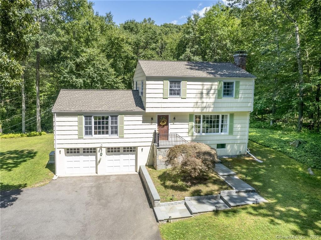 42 Collinswood Road Wilton, CT 06897 - Photo 1 of 1 front view of a house with a yard