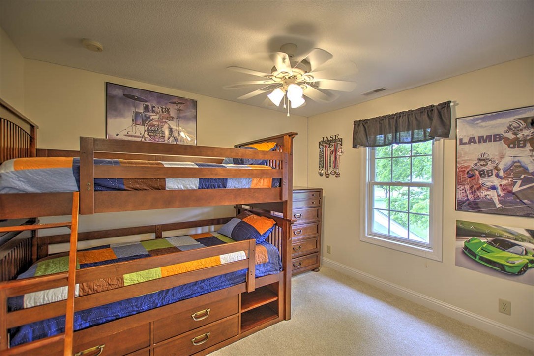 6750 Camp Warren Road Decatur, IL 62521 - Photo 18 of 34 a bedroom with a bed and a chandelier