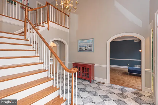a bathroom with a granite countertop sink a toilet a mirror and a shower