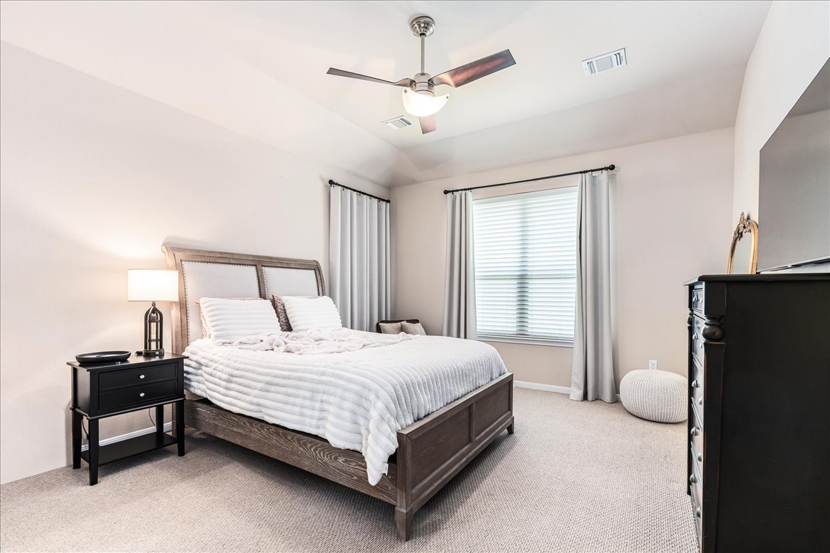 137 Navigator Drive Austin, TX 78717 - Photo 10 of 18 a bedroom with a bed furniture and a large window