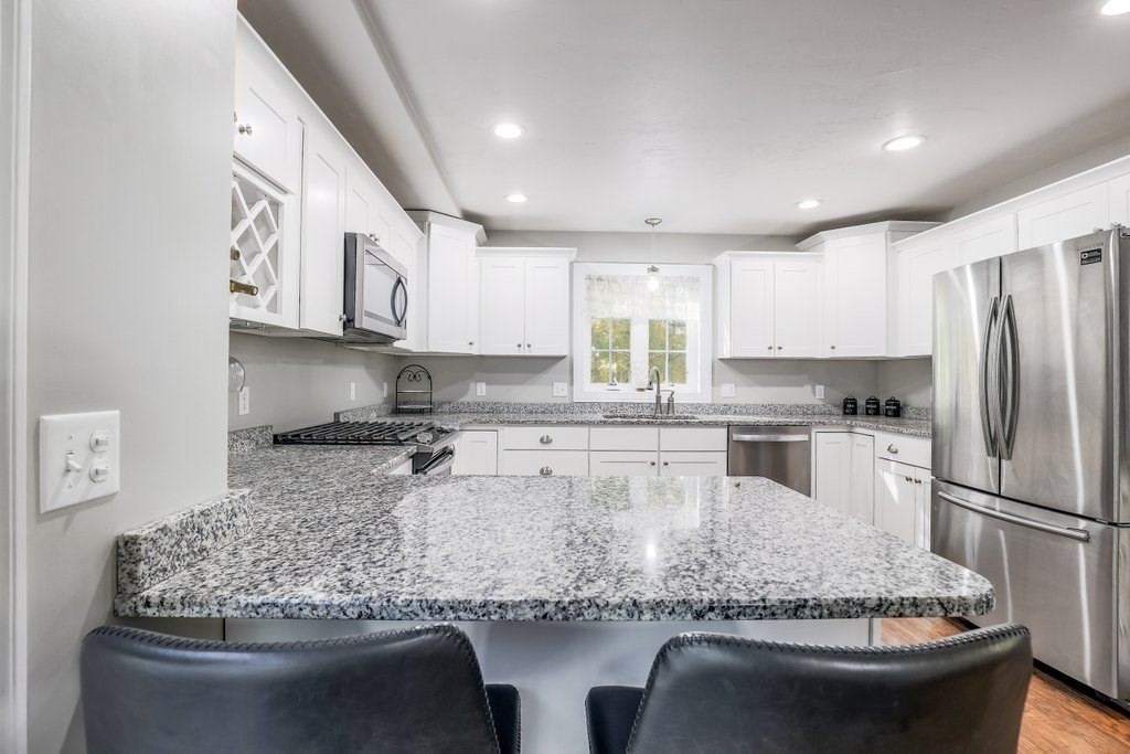 65 Haggerty Road Charlton, MA 01507 - Photo 12 of 34 a kitchen with stainless steel appliances granite countertop a sink stove and refrigerator