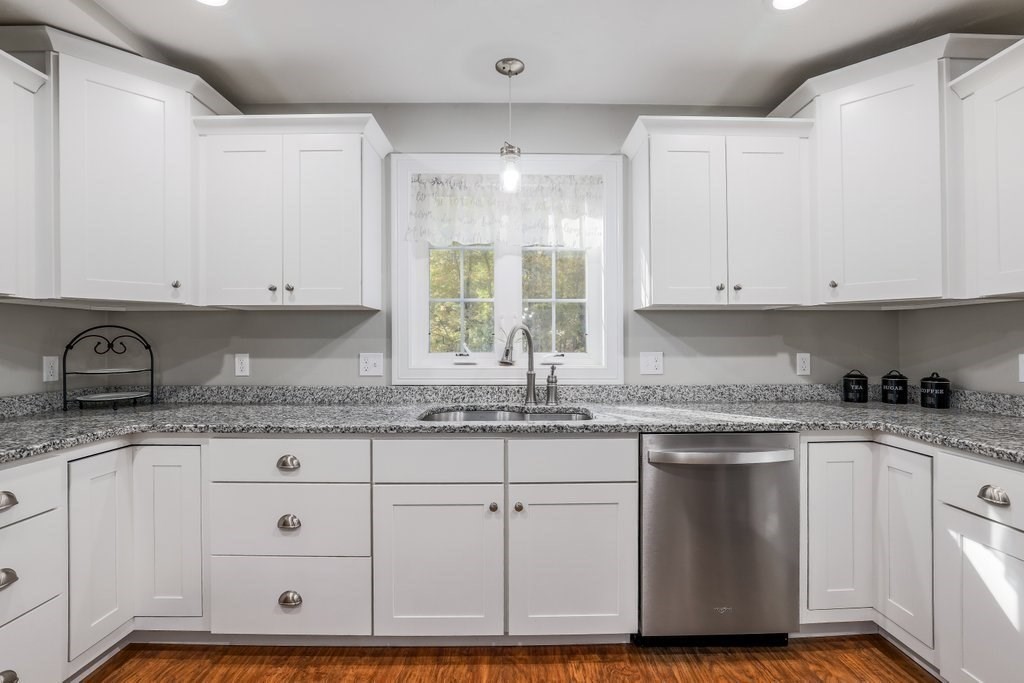 65 Haggerty Road Charlton, MA 01507 - Photo 13 of 34 a kitchen with granite countertop white cabinets and a sink