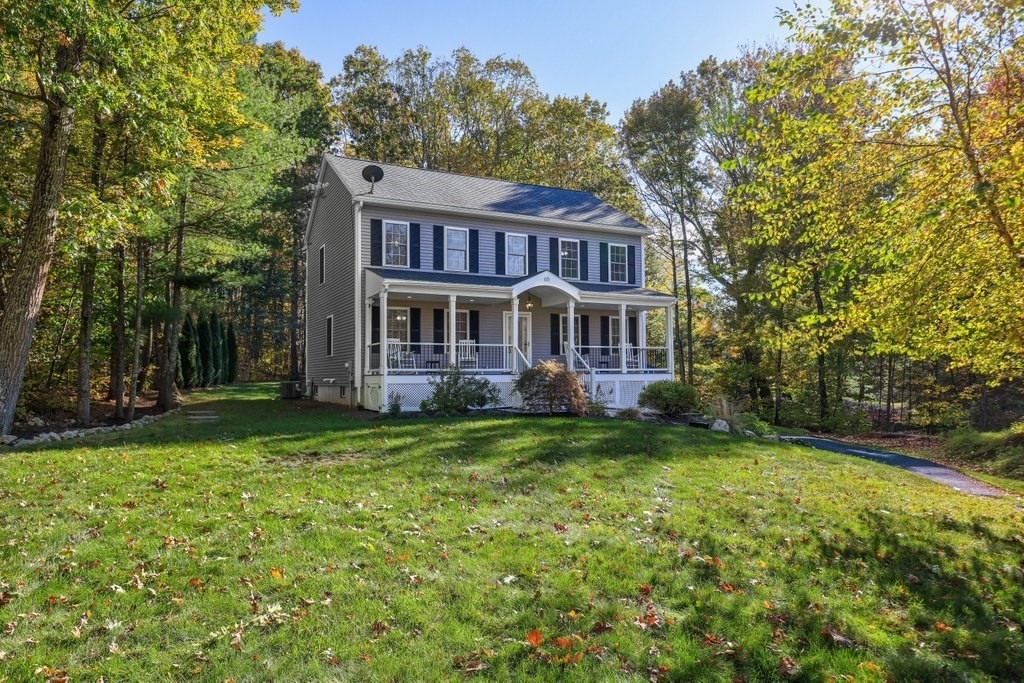 65 Haggerty Road Charlton, MA 01507 - Photo 2 of 34 a view of a house with a yard table and chairs