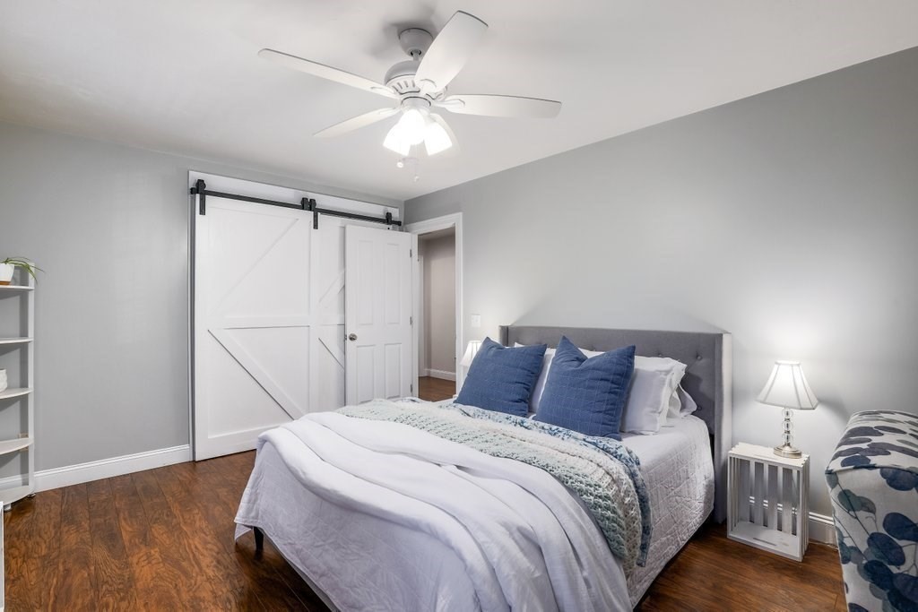 65 Haggerty Road Charlton, MA 01507 - Photo 28 of 34 a bedroom with a bed and a chandelier