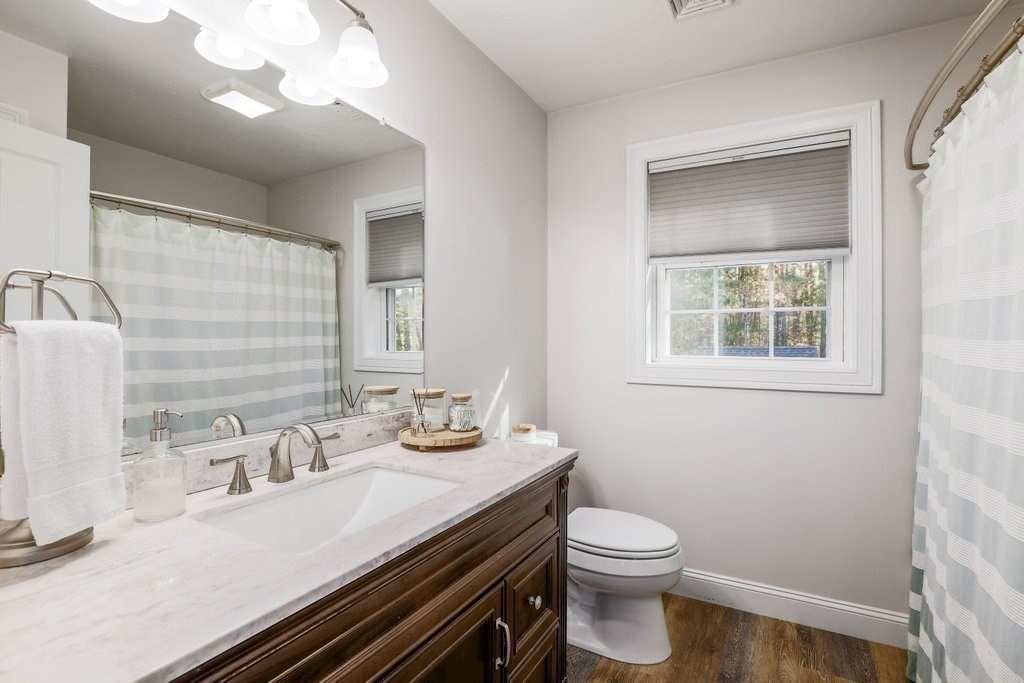 65 Haggerty Road Charlton, MA 01507 - Photo 30 of 34 a bathroom with a sink a toilet and a mirror