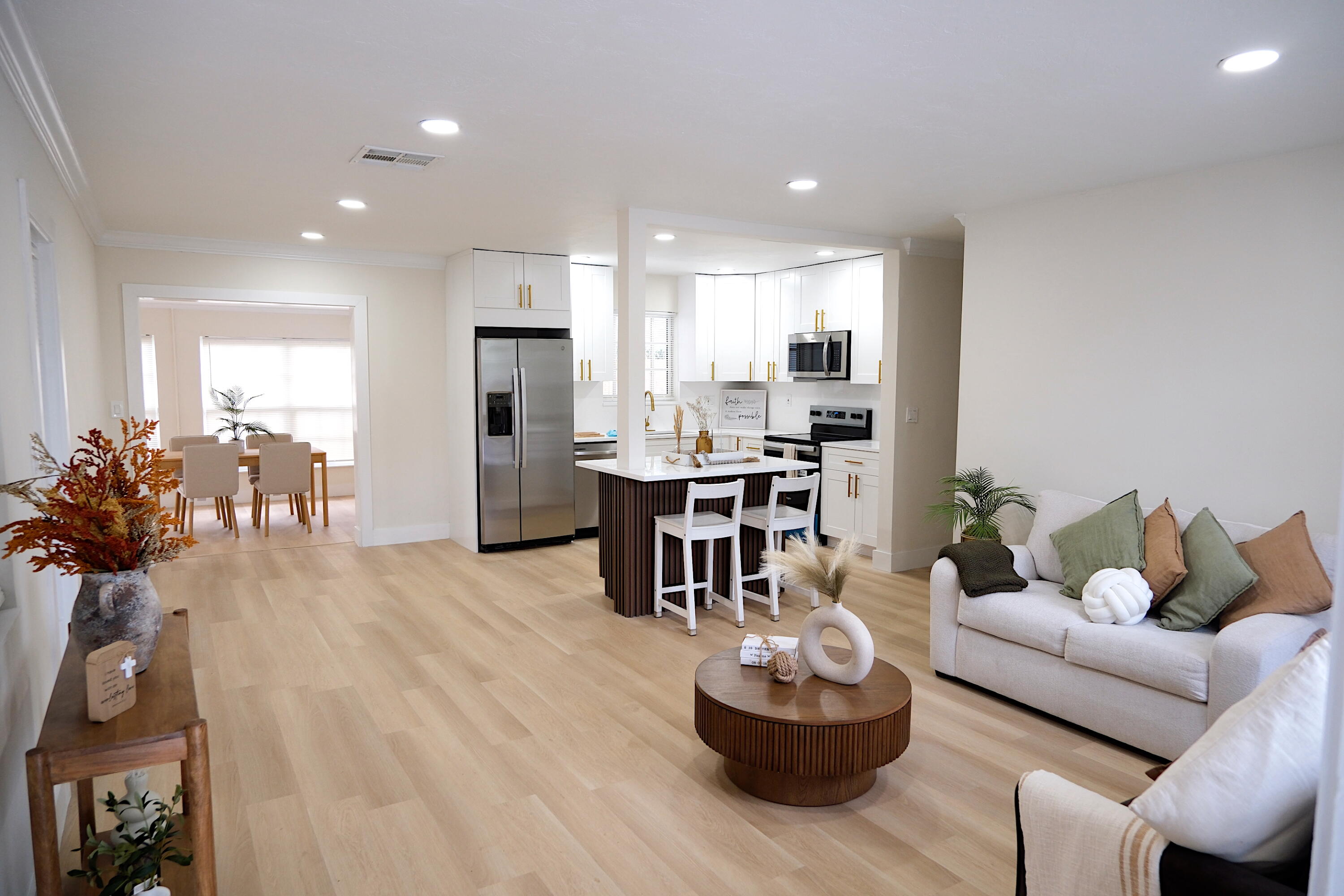 1084 Southwest 4th Avenue Pompano Beach, FL 33060 - Photo 7 of 35 a living room with furniture and a dining table with kitchen view