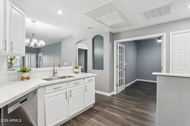 a kitchen with a sink cabinets and wooden floor