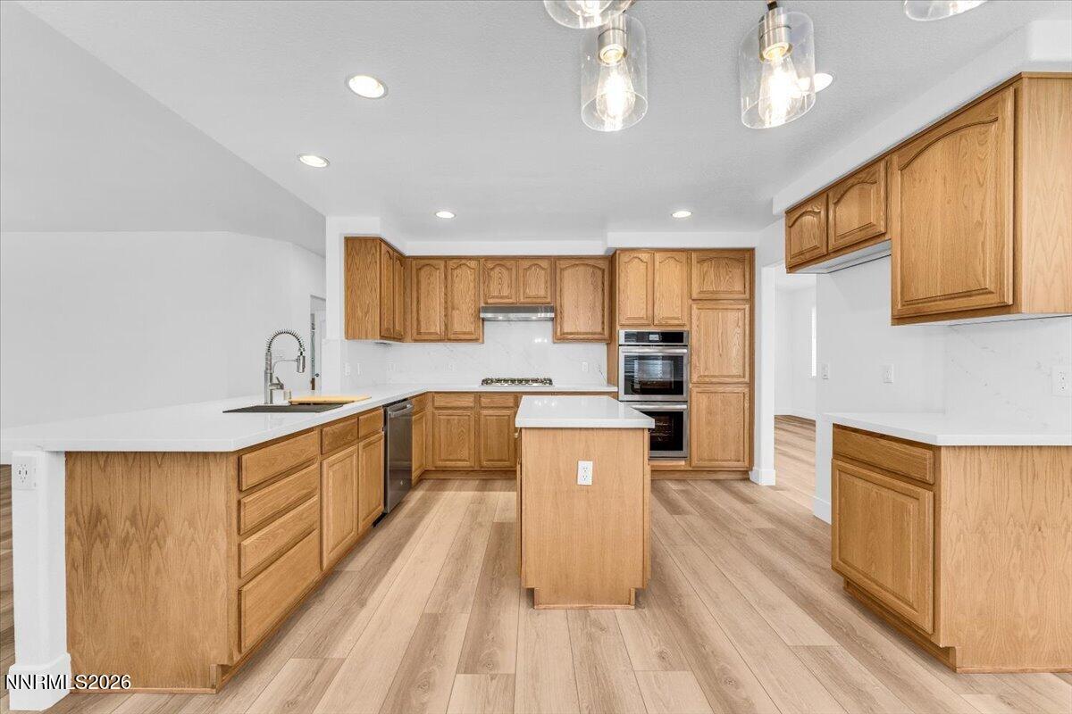 2329 Red Maple Court Reno, NV 89523 - Photo 12 of 39 a large kitchen with stainless steel appliances lots of counter space and a sink