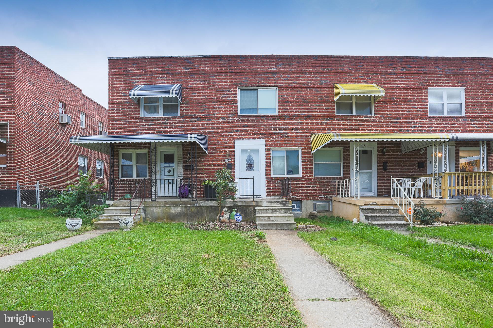 4119 Crest Heights Road Baltimore, MD 21215 - Photo 1 of 32 front view of a brick house with a yard table and chairs