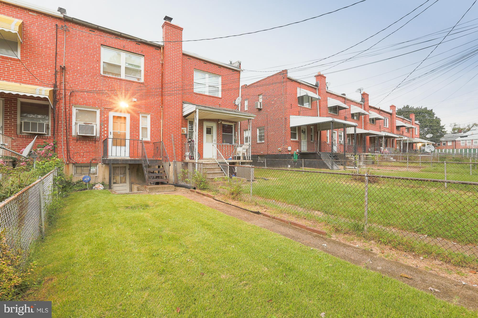 4119 Crest Heights Road Baltimore, MD 21215 - Photo 15 of 32 a front view of a building with a yard