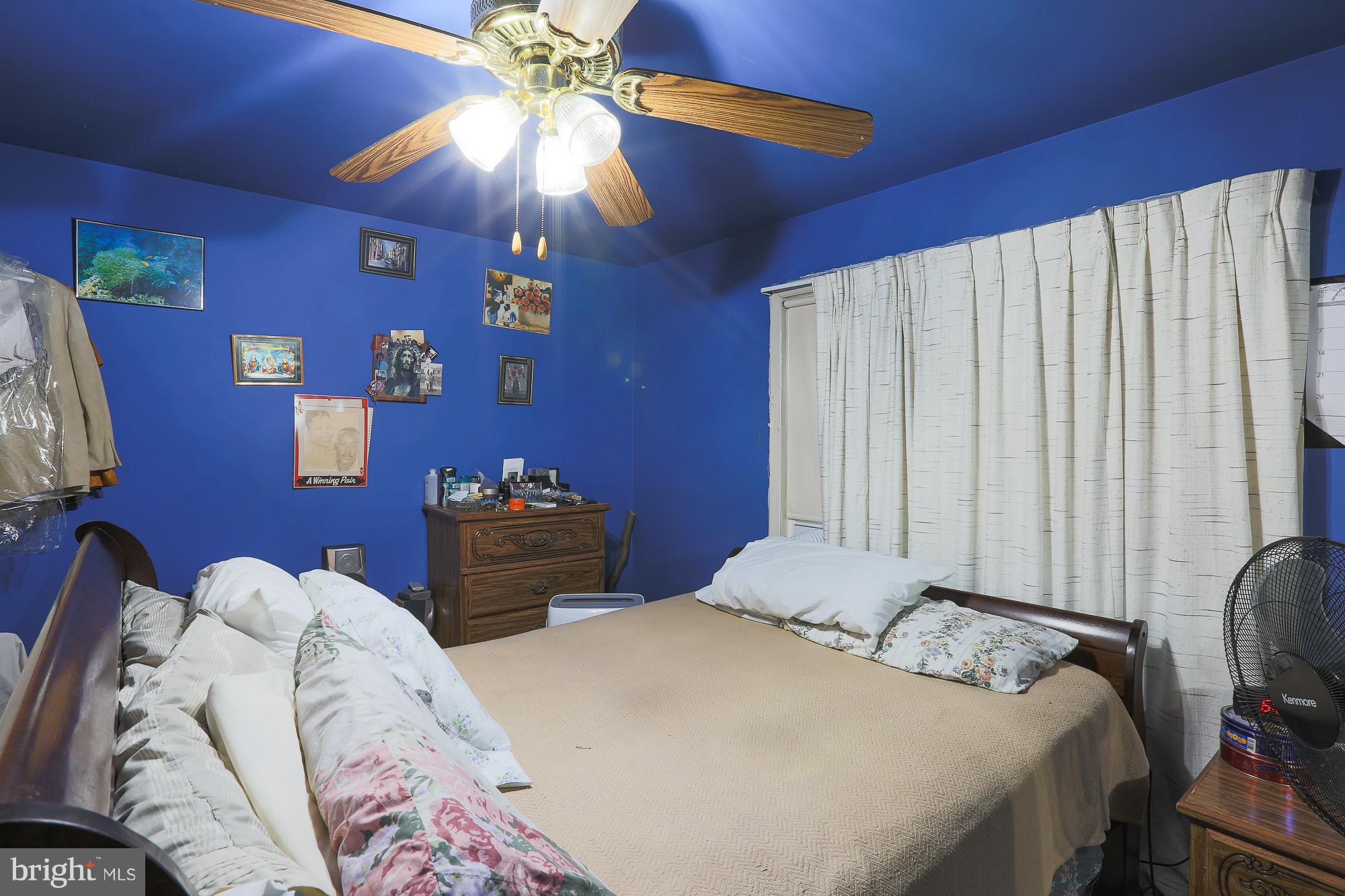 4119 Crest Heights Road Baltimore, MD 21215 - Photo 19 of 32 a bedroom with bed and a chandelier