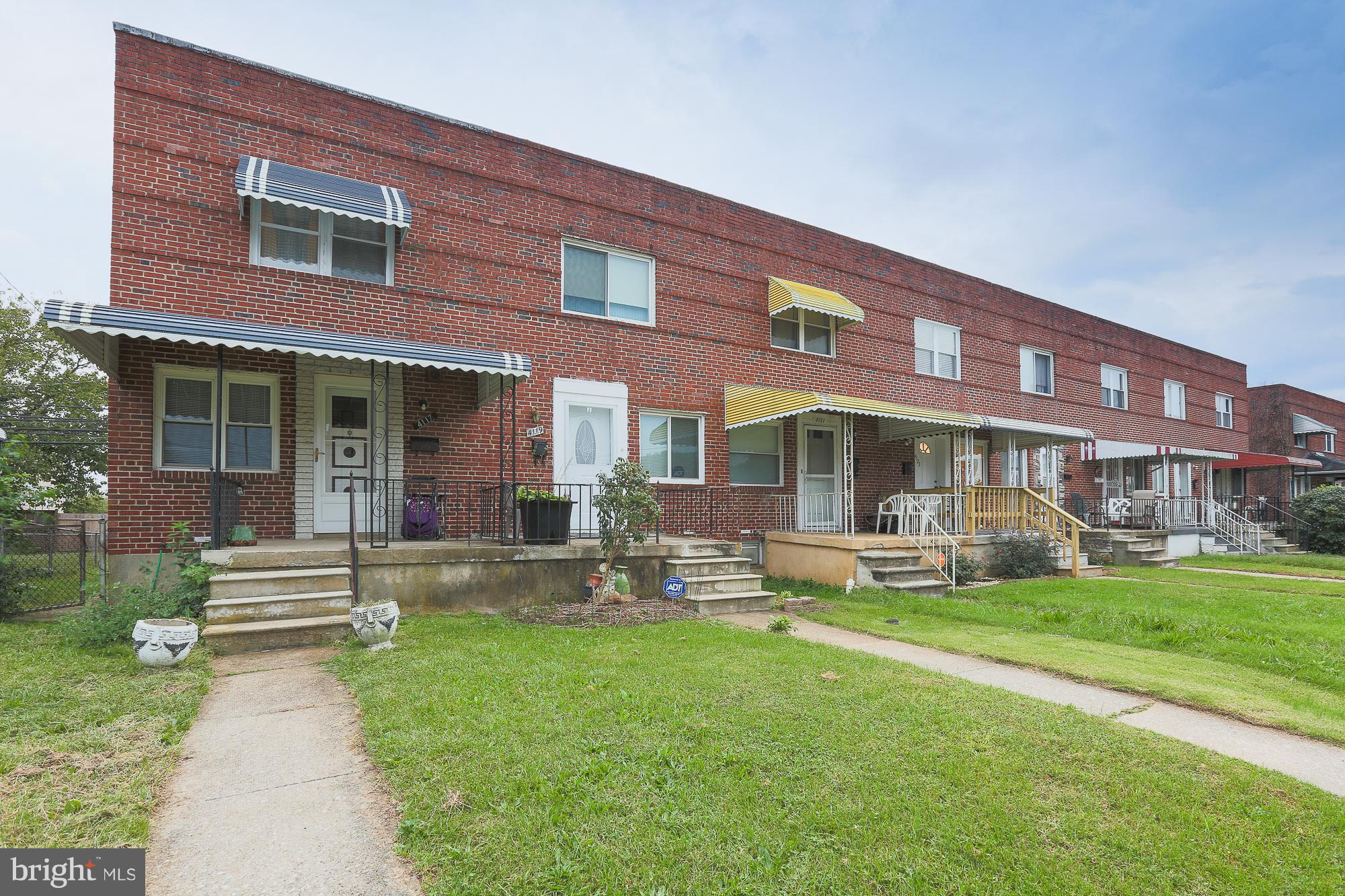 4119 Crest Heights Road Baltimore, MD 21215 - Photo 3 of 32 a front view of building with outdoor seating and yard