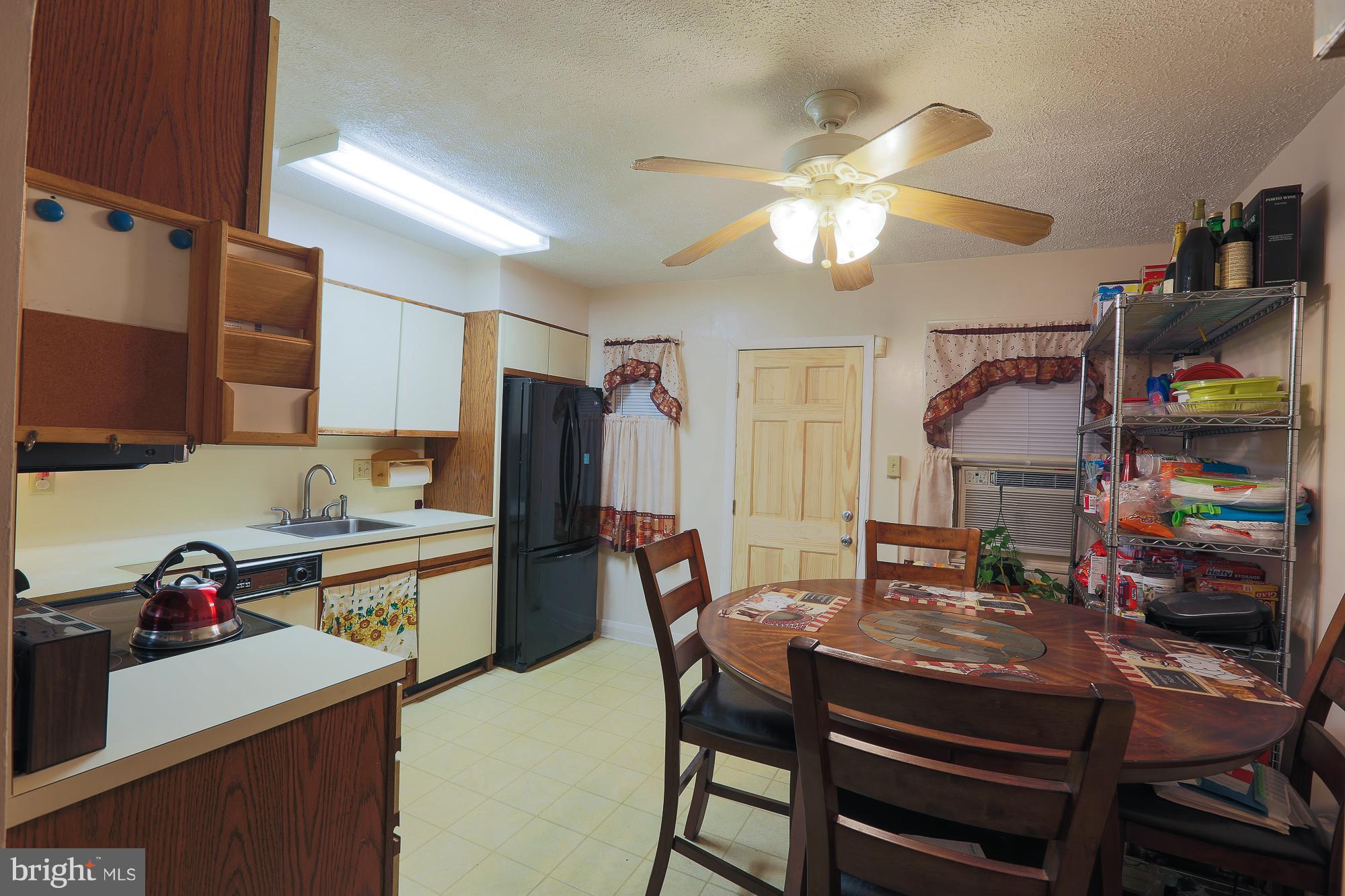 4119 Crest Heights Road Baltimore, MD 21215 - Photo 28 of 32 a view of a dining room with furniture and a chandelier fan