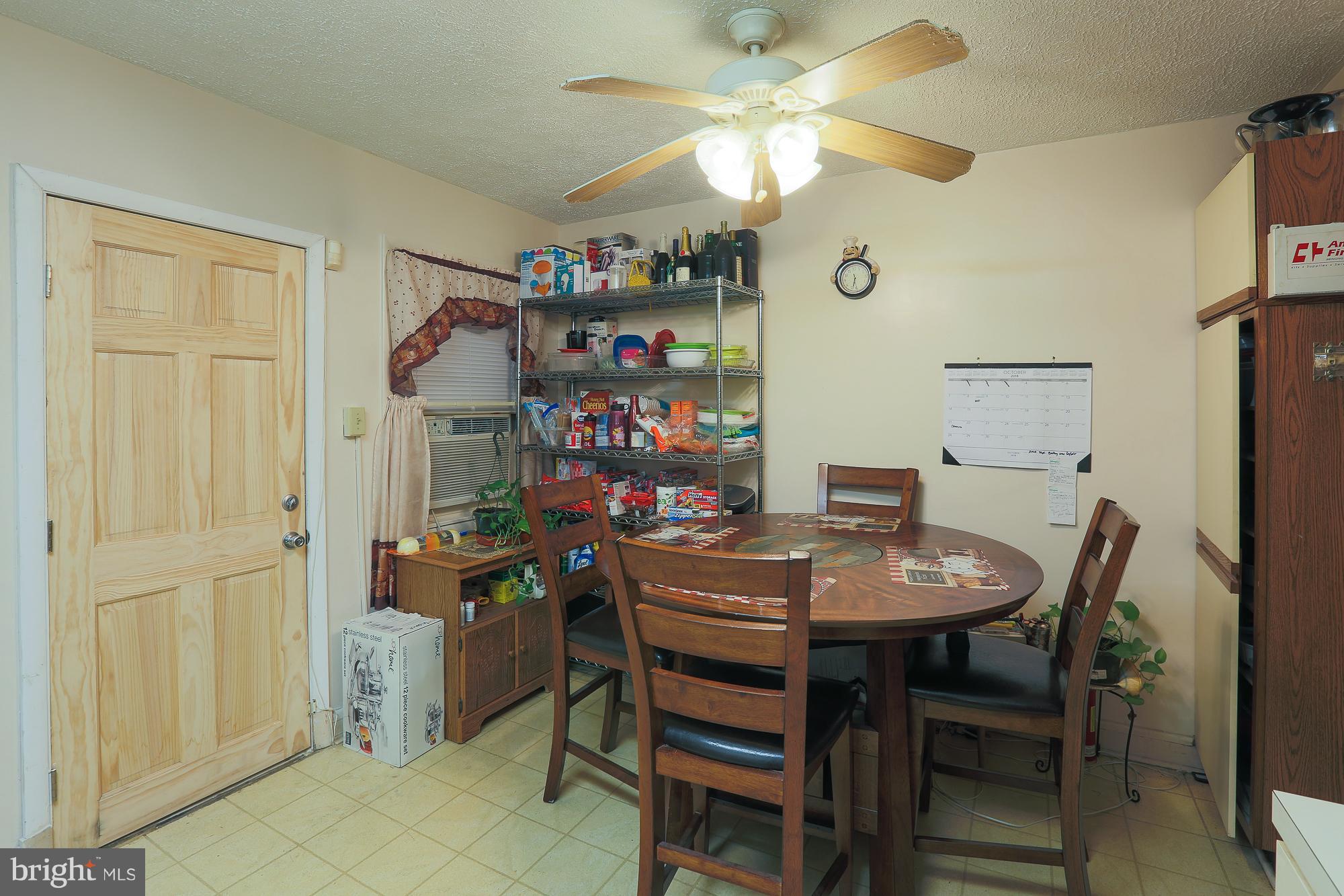 4119 Crest Heights Road Baltimore, MD 21215 - Photo 30 of 32 a view of a dining room with furniture and a chandelier fan