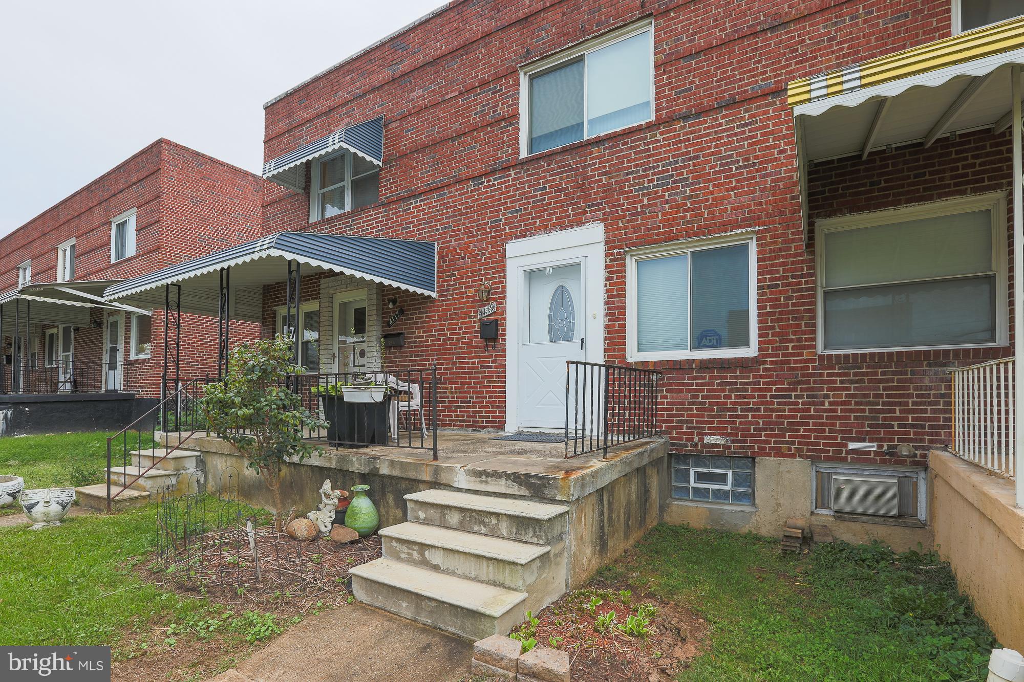 4119 Crest Heights Road Baltimore, MD 21215 - Photo 6 of 32 a front view of a house with a garden
