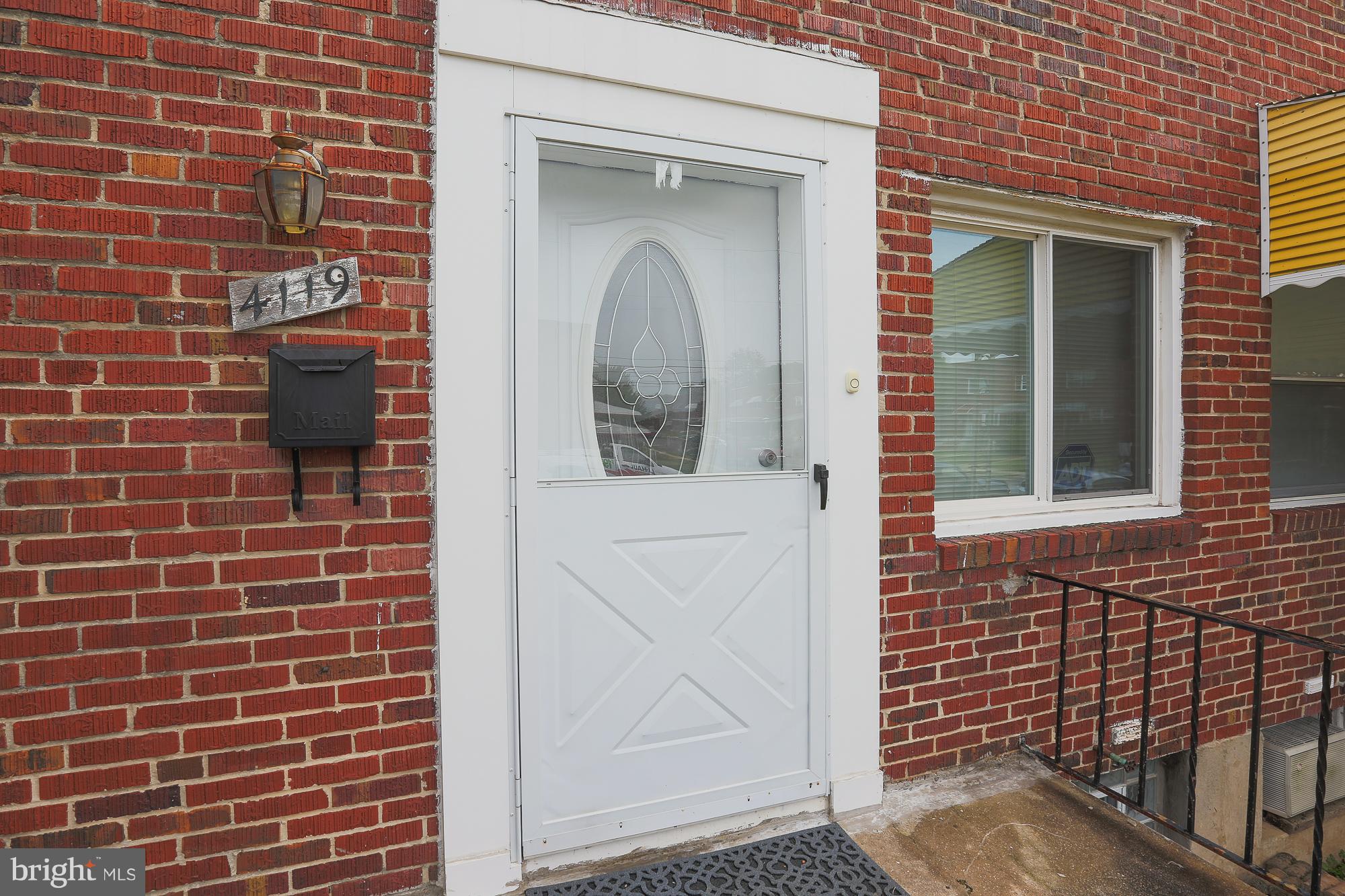 4119 Crest Heights Road Baltimore, MD 21215 - Photo 7 of 32 a view of a brick house with a door